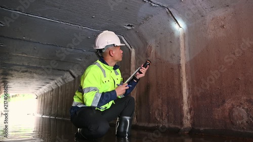 Maintenance Engineer Examining Underground Drainage System and Water Infrastructure