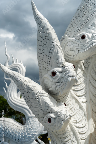 Картината върху платно Intricate white multi-headed serpent sculpture against a dramatic cloudy sky