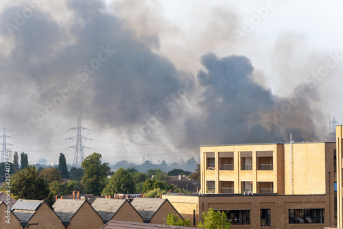 Photography Thick Black Smoke Rising Over Residential Area With Industrial Buildings and Tre