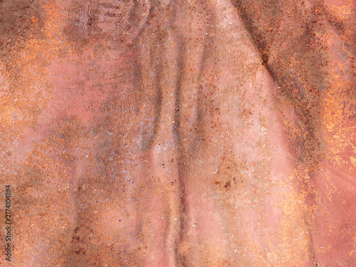 Quadro su tela Crumpled rusted iron sheet displaying weathered red corrosion under even natural