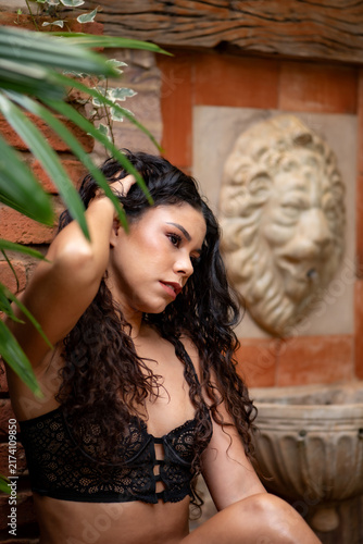 Obraz na płótnie Sensual photoshoot of a beautiful young Brazilian woman; a beautiful young Brazilian woman in a sensual photoshoot during the Brazilian summer, natural light, selective focus
