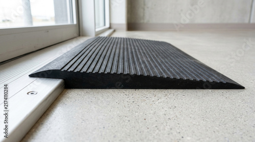 Black rubber threshold transition ramp against aluminum track