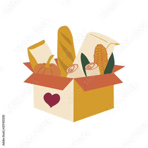 Food donation box filled with grocery supplies, bread, corn and canned goods. Thanksgiving charity concept represents food drive support and hunger relief.