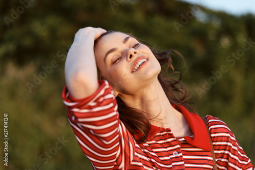 Fotografie Smiling woman enjoying lifestyle outdoors in summer