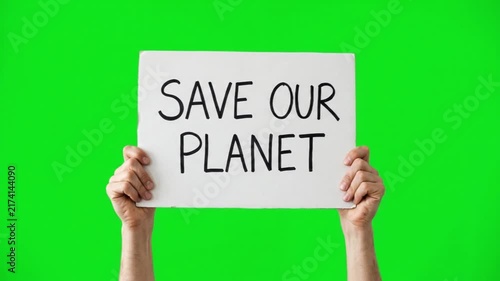 Hands holding a banner sign with the text save our planet on a green screen chroma key background