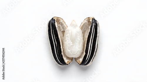 Peeled sunflower seed with black striped shell. Open sunflower seed kernel. Macro of raw organic snack for healthy diet. isolated on White Background