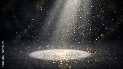 Spotlit, dusty, dark stage with shimmering gold particles falling