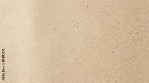 A softly lit abstract beige background features gentle texture and subtle tonal variations for a minimalist calming and peaceful visual aesthetic