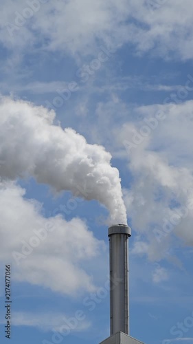 Smoke from chimney aganist a blue sky