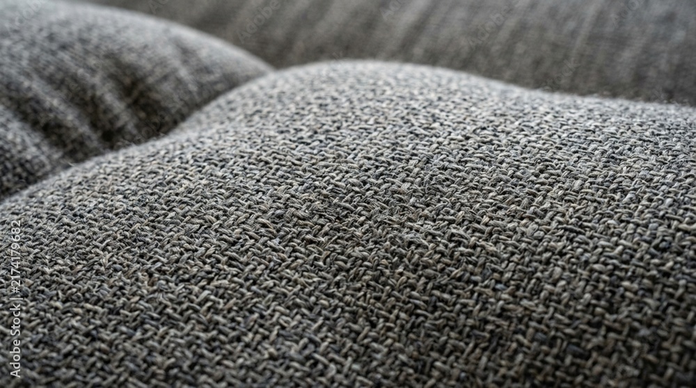 Obraz premium Close-up of textured gray fabric with soft curves and shadows
