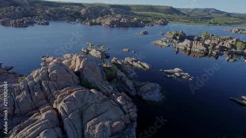 Aerial flyover of a lake landscape with many rock formations 