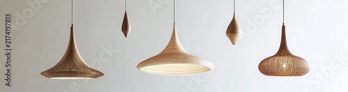 Five Textured Brown Pendant Lights Hanging Against a White Wall
