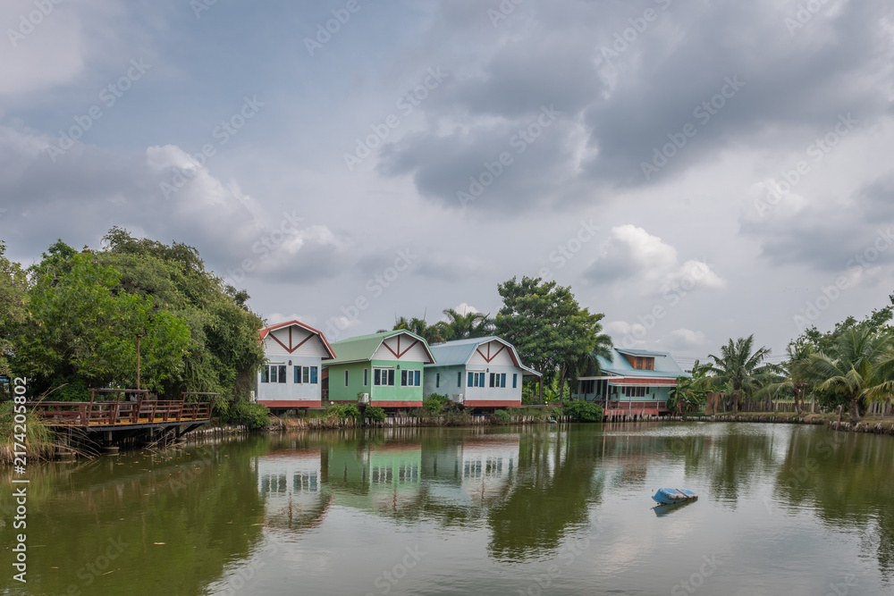Fototapeta premium colorful holiday homes on a cloudy day, with green trees 
