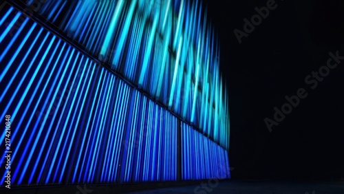 Vibrant blue and turquoise vertical lights, sharp lines, abstract architectural lighting