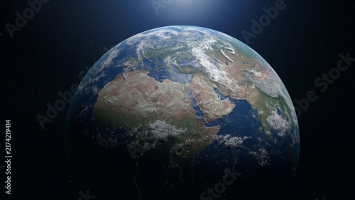 Earth viewed from space with sunlight illuminating Africa, Europe and Asia, clouds and city lights against a starry sky.
