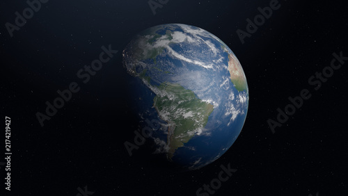 Earth viewed from space with the Americas visible, partly sunlit, surrounded by dark starry sky and scattered clouds.