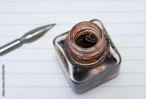 Photography open red ink bottle and pen nib