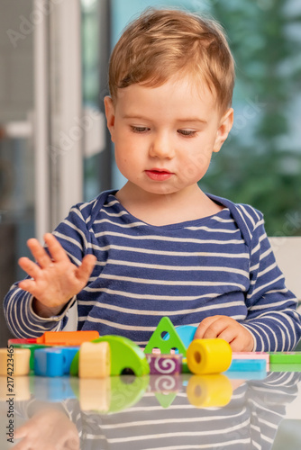 Toddler learning colors and shapes through creative educational play.
