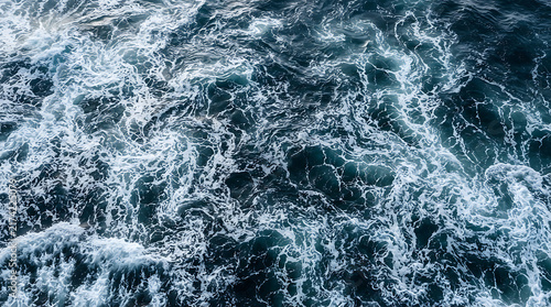 Deep ocean water texture with white sea foam created by strong waves and wind currents.