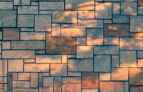 Stone Wall with Dappled Sunlight and Shadows