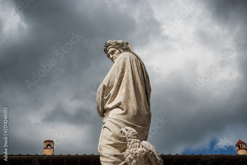 A statue of Dante Alighieri near the basilica of Santa Croce in Florence Italy