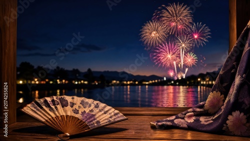  Folded fan and yukata sleeve on doorstep with fireworks over Sumida River, Tokyo summer celebration. 