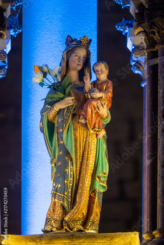 A polychrome statue of Virgin Mary holding the infant Jesus.