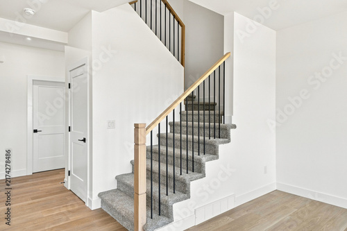 Minimalist home interior features a wooden staircase