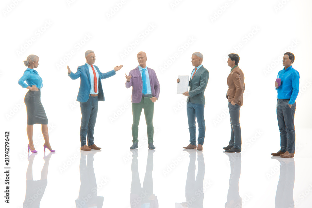 Fototapeta premium Miniature figures engaged in conversation in a bright environment