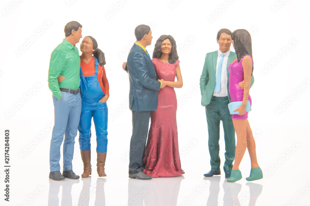 Obraz premium Miniature people gather in a social setting during a festive event with colorful outfits and various poses