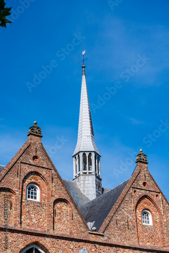 Pointed bell tower of old puritan church in the Nederlands