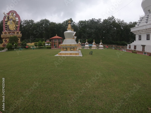 Obraz na płótnie A peaceful outdoor view of a Buddhist monument or Buddha statue situated in a landscaped garden