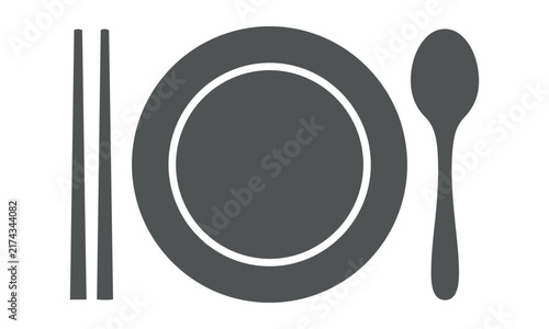 Minimalist dining place setting icon featuring a circular plate with chopsticks and a spoon on a white background for an Asian cuisine and restaurant concept