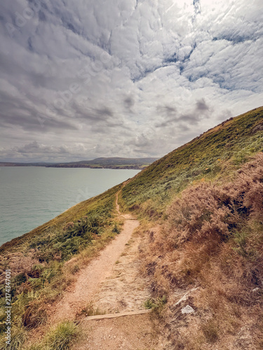 Photography Scenic view of the Wales Coast Path around Dinas Head, which is a headland exten