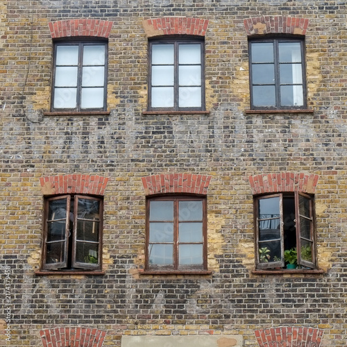 Old brick warehouse facade with faded ghost sign lettering