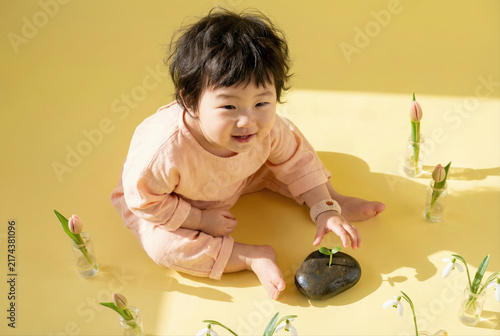 Babys gentle touch with spring growth