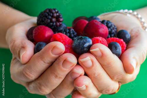 Forest fruits held in a woman's hands