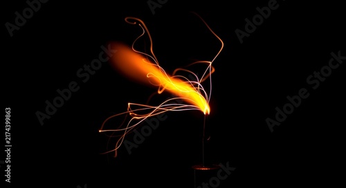 Dynamic Glowing Fire Element with Energetic Sparks Against Dark Background