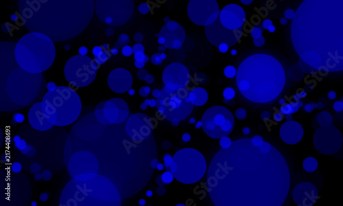 Glowing royal blue bokeh light circles abstract particle background with defocused blur effect on black