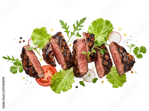 Sliced grilled steak with fresh salad ingredients on black background beef steak, grilled, sliced, beef, meat, medium-rare, juicy, red meat, salad, lettuce, arugula, radish, tomato, herbs, parsley, ci