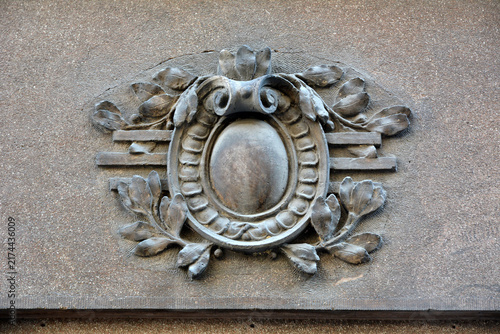 Bild auf Leinwand Architectural stone cartouche relief with laurel wreath motif on building facade
