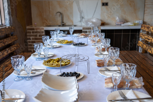 Elegant Dining Table Set with Traditional Appetizers and Olives in Restaurant.