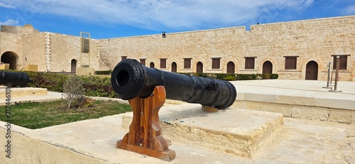 Old historic cannon in the inner courtyard of the Citadel of Qaitbay, a 15th-century defensive fortress located on the Mediterranean sea coast, on Pharos Island in Alexandria, Egypt. 