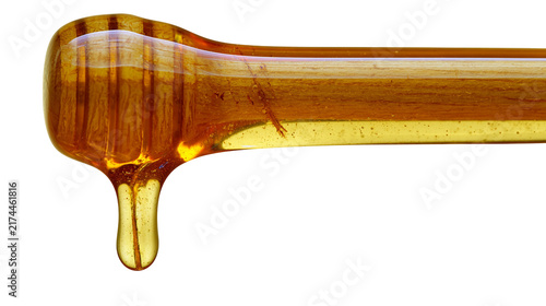 Fotografía Isolated honey dipper dripping natural golden sweet liquid for healthy food and