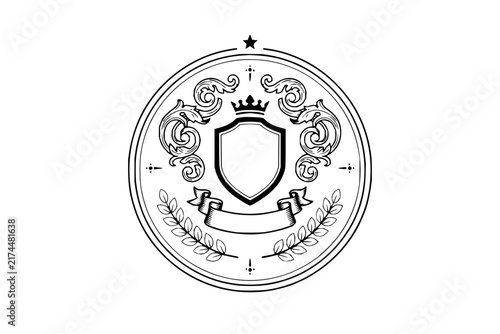 Vintage heraldic crest with crown and shield inside a decorative circular frame with blank ribbon banner