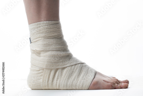 Heel spur. Foot disease. A person’s bandaged leg on a white background.
