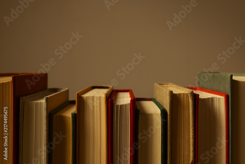 Canvastavla Close-up of vintage books arranged together in warm natural light, highlighting aged pages, textured bindings and earthy tones