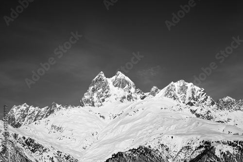 Black and white snowy mountains at sunny winter day