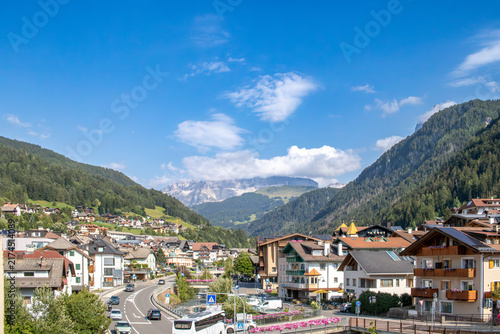 Fotografie Ortisei, Val Gardena, Italy - August 2026: The picturesque mountain village is nestled in a green valley in the South Tyrol region