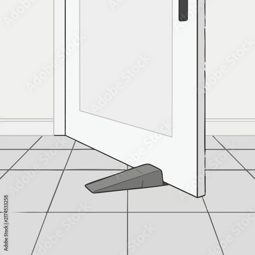Doorstop holding white door open on tiled floor